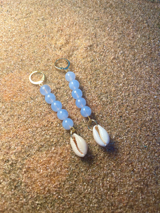 Light blue and gold earrings with a cowrie shell