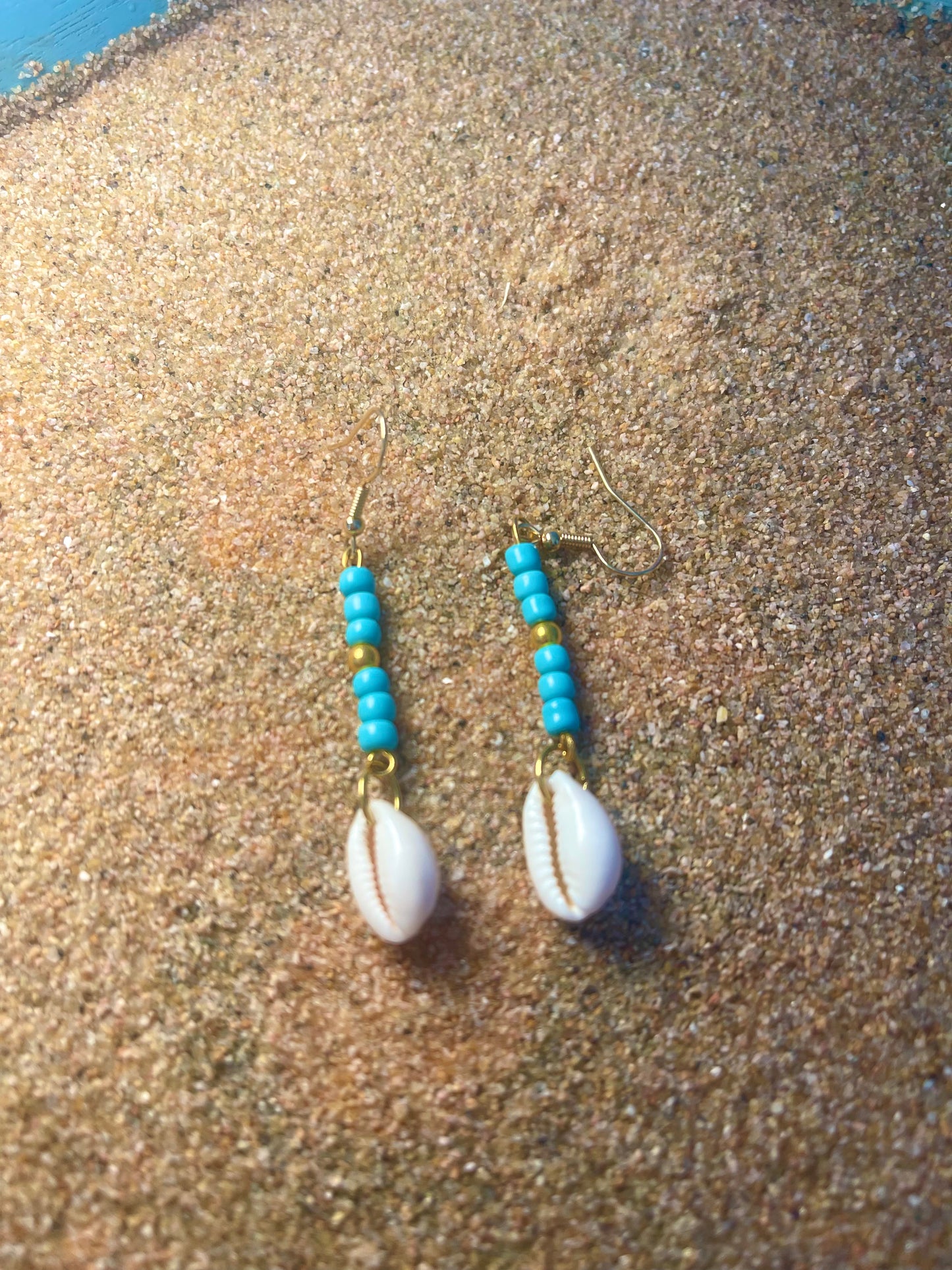 Blue and gold beaded Earrings with a cowrie shell