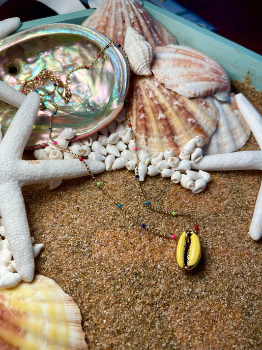 One of a kind. Gold and rainbow necklace with a yellow cowrie shell