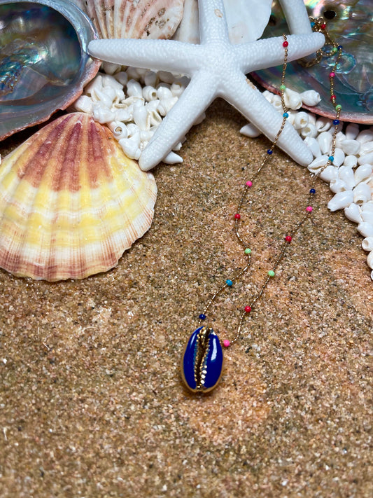 One of a kind. Gold and rainbow necklace with a blue cowrie shell