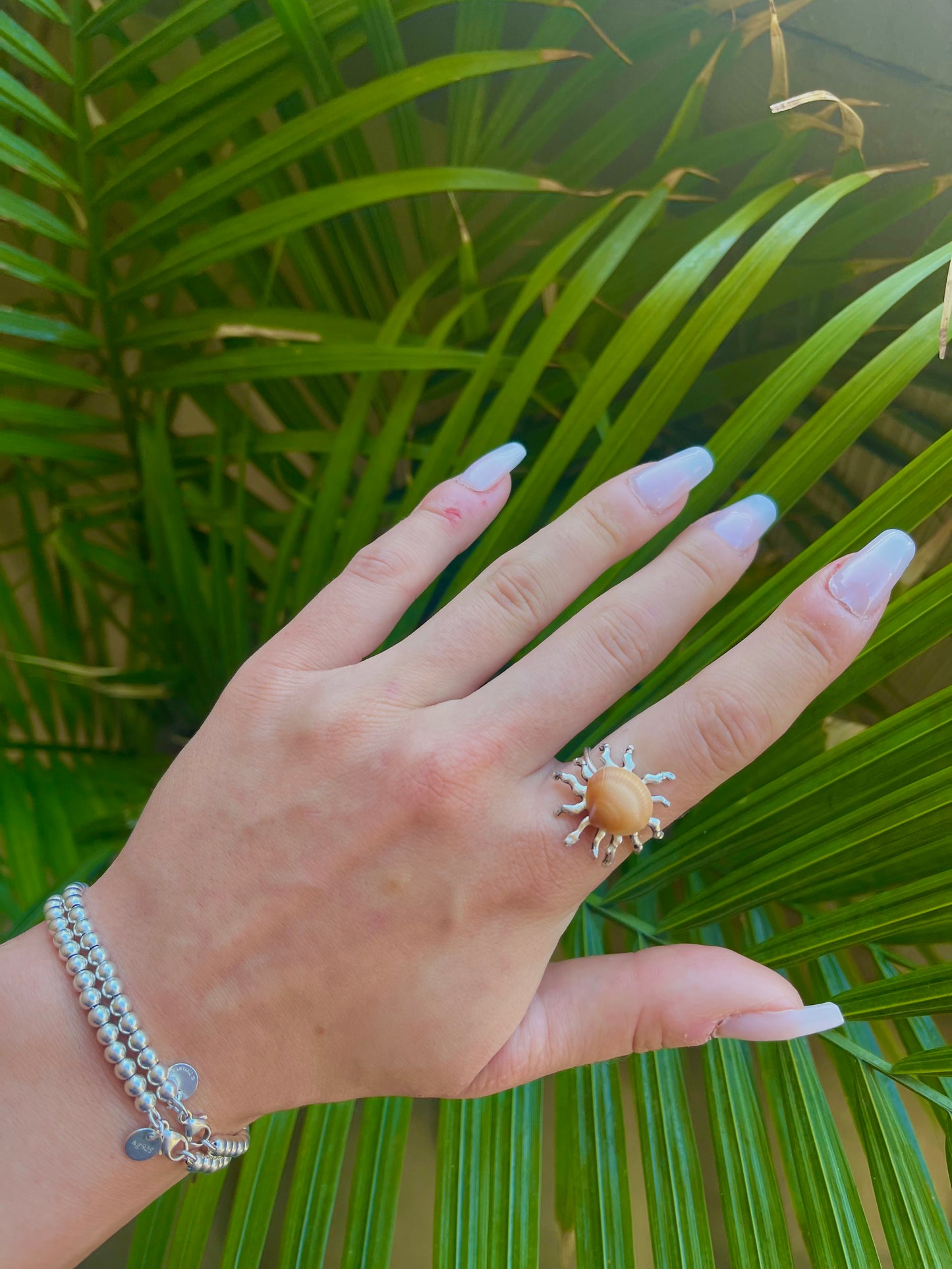 Silver sun and orange seashell ring