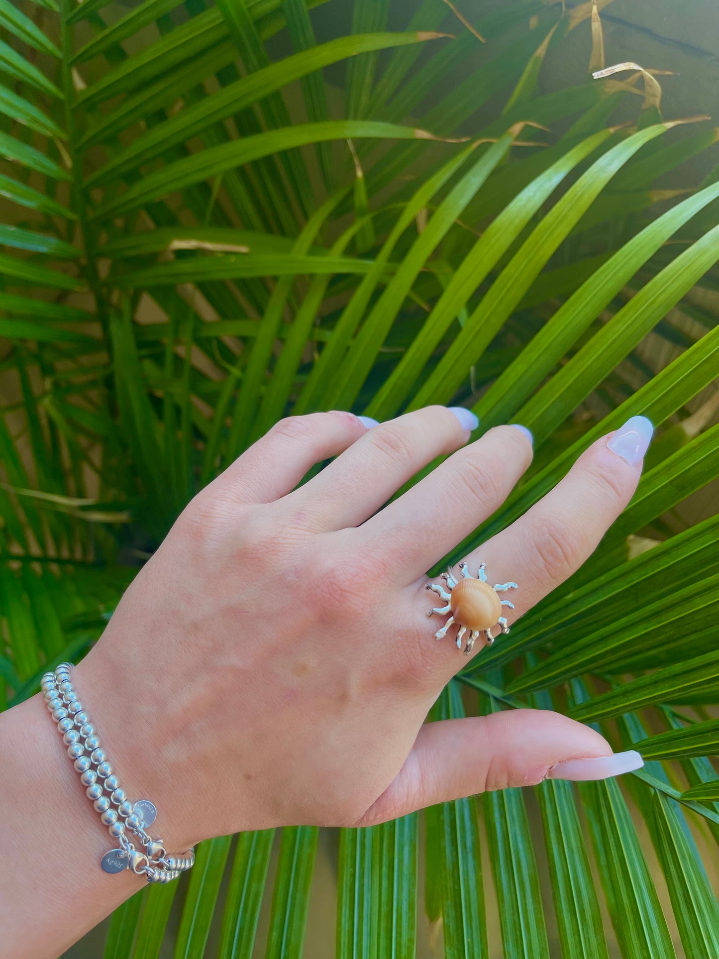 Silver sun and orange seashell ring