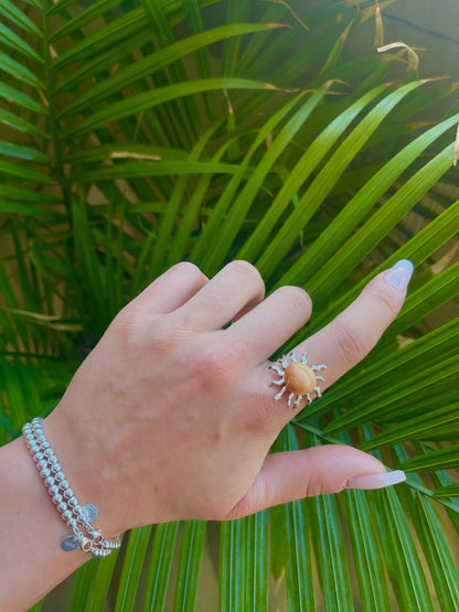 Silver sun and orange seashell ring